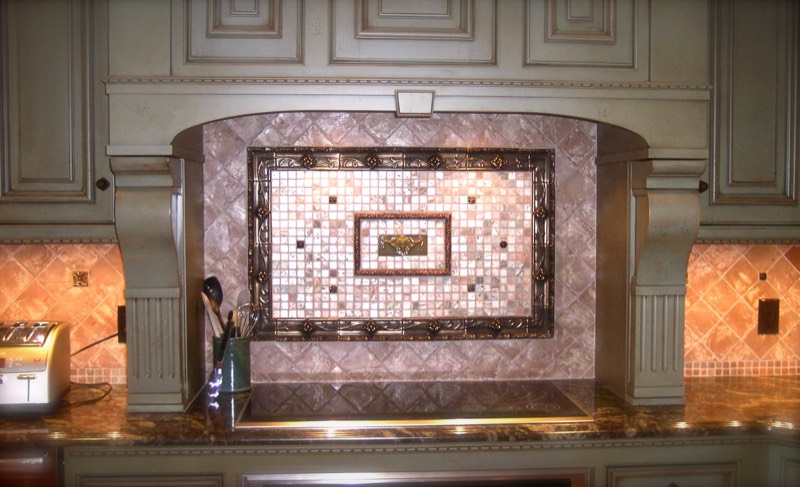 Framed mosaic tile medallion set into a range backsplash