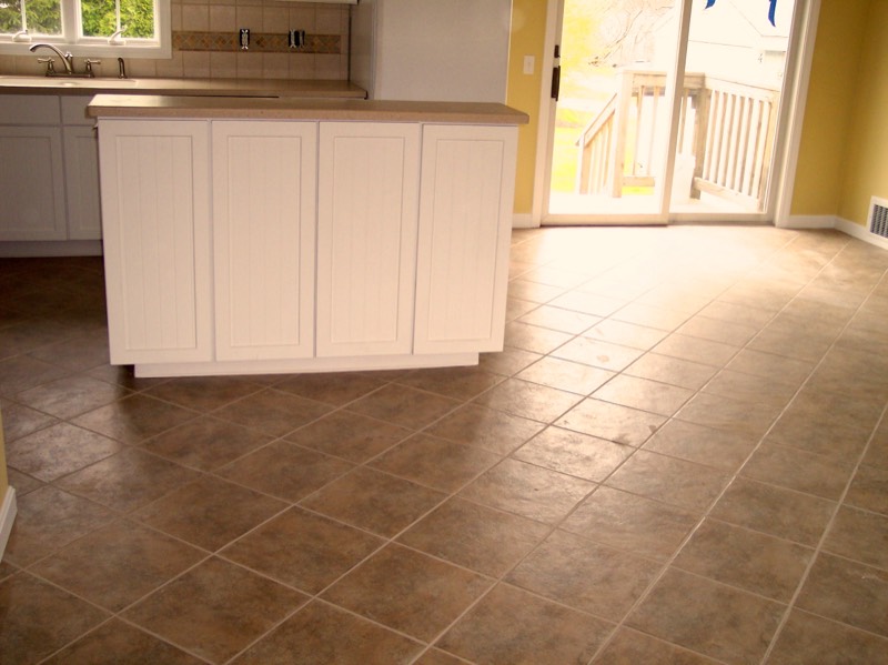 Diagonally laid tile floor running through a kitchen and dining area