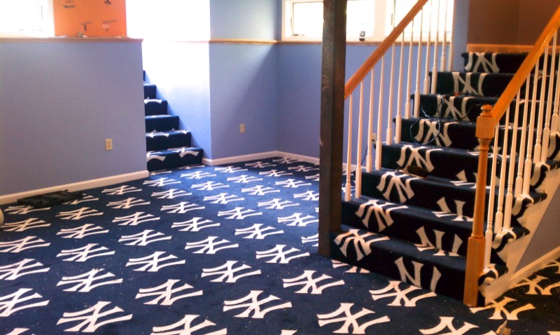 Custom patterned carpet installed on a basement floor and staircase