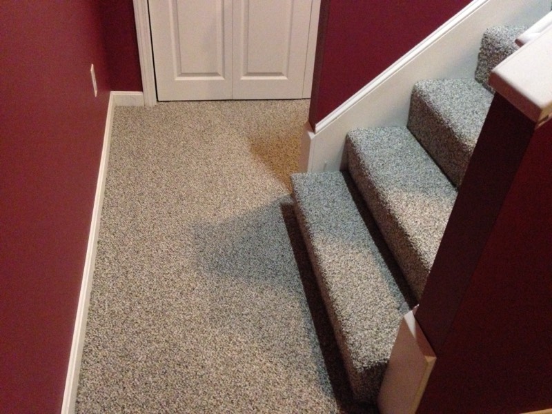 Flecked beige carpet installed on a landing and stair treads